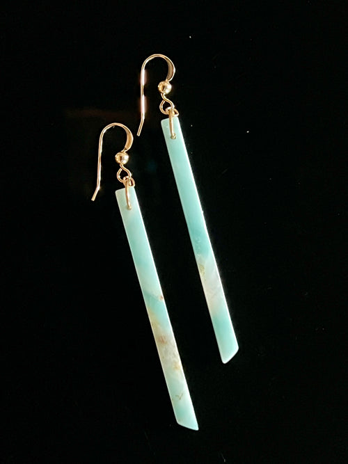 Pair of Amazonite long bar drop earrings with 14K gold fill fish hook wires on a black background, showing vivid blue-green stone with natural cream inclusions