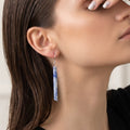 Blue aventurine long bar earring worn on a model with dark hair, showing scale and fit with a sterling silver fish hook wire against a neutral background
