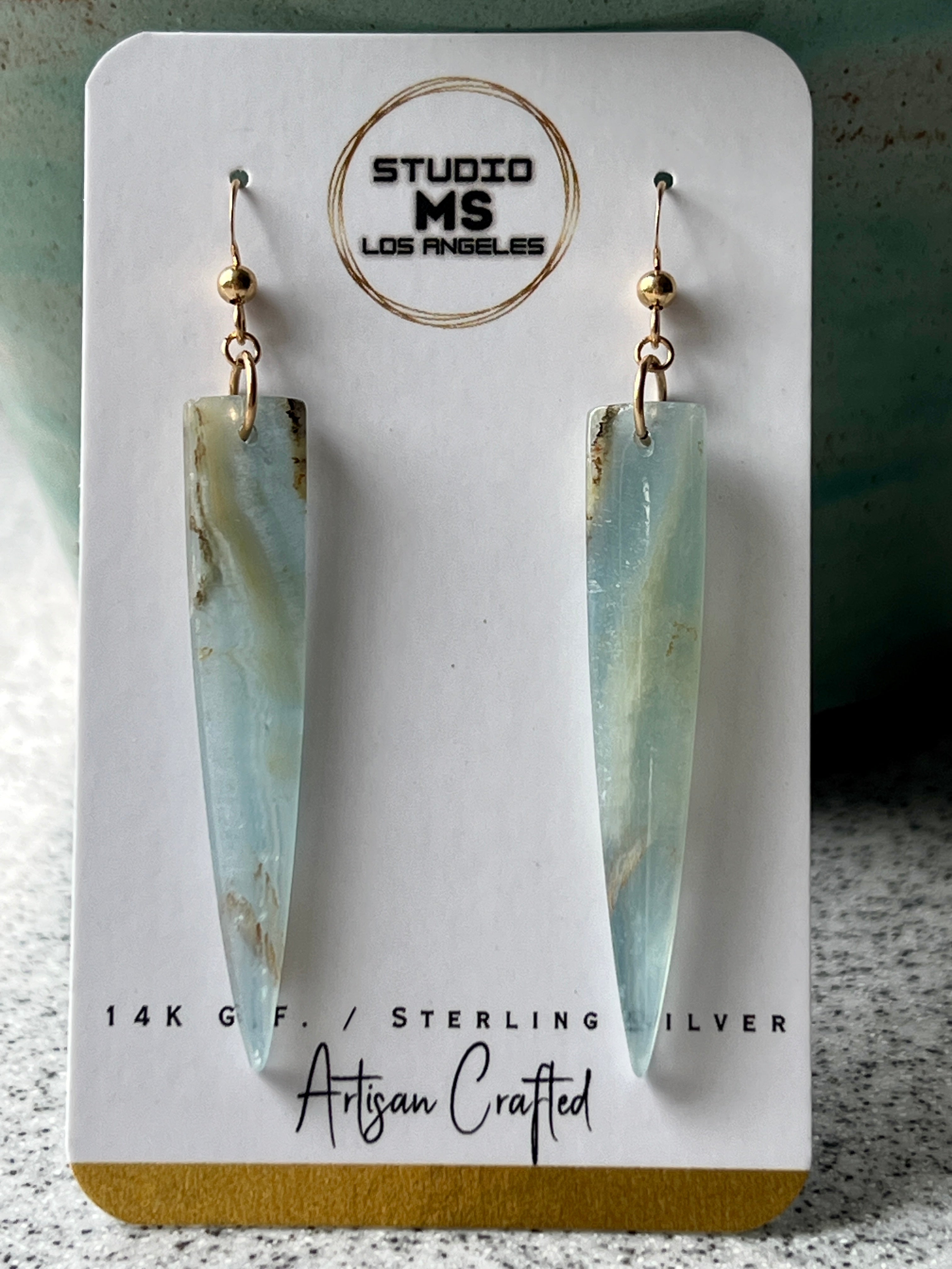 Lemurian Calcite dagger earrings displayed on Studio MS Los Angeles jewelry card, labeled 14K Gold Fill and Sterling Silver, Artisan Crafted