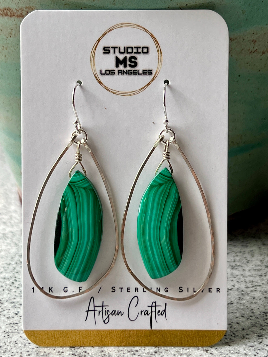 Malachite and sterling silver freeform dangle earrings on Studio MS Los Angeles jewelry card, labeled Sterling Silver, Artisan Crafted
